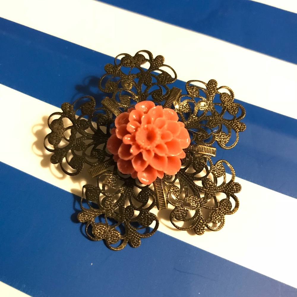 Metal flower brooch with flower detail